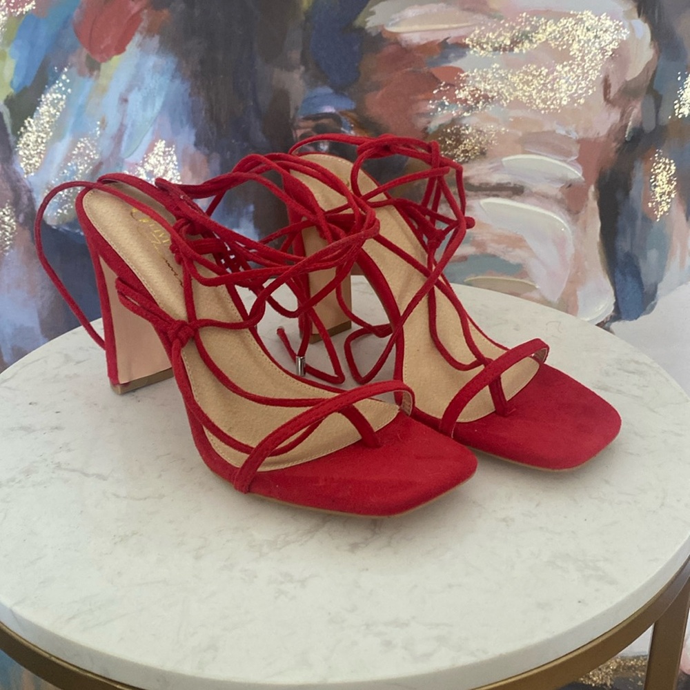 Red strappy heels.
